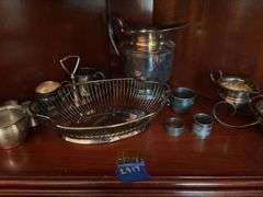Contents of two shelves: silverplated tea and coffee pots, misc serving pcs