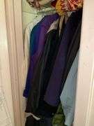 *In living room* Contents of closet: ladies jackets sz: lg/16, tablecloths and linens lot