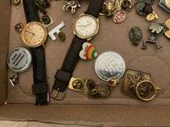 Wrist watches by Gervais Penard, Timex, truck belt buckle, lapel pins, misc