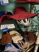 Contents of three shelves: ladies hats and purses, baseball caps,