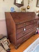 Slant front desk w/ compartmented interior w/ seashell inlaid prospect door, graduated drawers w/ inlaid escutcheons, ogee bracket feet  50x21x43