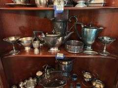 Contents of two shelves: silverplated tea and coffee pots, misc serving pcs
