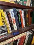 Book contents of three shelves: history, short stories, National Geographics, misc