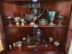 Contents of two shelves: silverplated tea and coffee pots, misc serving pcs