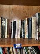 Book contents of four shelves: Bibles, golf, reference, misc