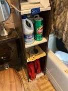 Contents of bathroom except fur coats: collectibles, health items, boots, cleaning supplies, misc