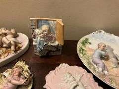 Collection of bisque plaques w/ cherubs and children in relief, and bisque match pocket