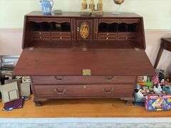Slant front desk w/ compartmented interior w/ seashell inlaid prospect door, graduated drawers w/ inlaid escutcheons, ogee bracket feet  50x21x43