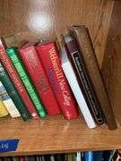 Book contents of four shelves: Bibles, golf, reference, misc