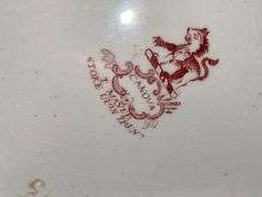 Contents of shelf: red Staffordshire transfer printed teapot, cup plates, plates