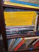 Book contents of three shelves: history, short stories, National Geographics, misc