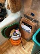 Contents of bathroom except fur coats: collectibles, health items, boots, cleaning supplies, misc