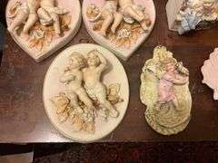 Collection of bisque plaques w/ cherubs and children in relief, and bisque match pocket
