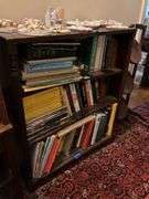 Book contents of three shelves: history, short stories, National Geographics, misc