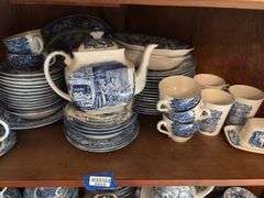 Contents of two shelves: Liberty Blue Historic Colonial Scenes dinnerware set w/ serving pcs