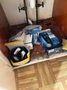 Contents of bathroom except fur coats: collectibles, health items, boots, cleaning supplies, misc
