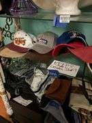 Contents of three shelves: ladies hats and purses, baseball caps,