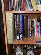 Book contents of four shelves: Bibles, golf, reference, misc