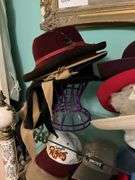 Contents of three shelves: ladies hats and purses, baseball caps,