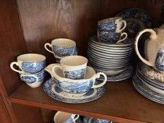 Contents of two shelves: Liberty Blue Historic Colonial Scenes dinnerware set w/ serving pcs