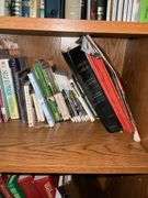 Book contents of four shelves: Bibles, golf, reference, misc