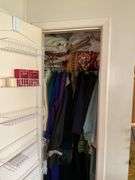 *In living room* Contents of closet: ladies jackets sz: lg/16, tablecloths and linens lot