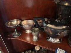 Contents of two shelves: silverplated tea and coffee pots, misc serving pcs