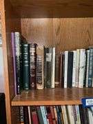 Book contents of four shelves: Bibles, golf, reference, misc