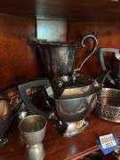 Contents of two shelves: silverplated tea and coffee pots, misc serving pcs