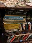 Book contents of three shelves: history, short stories, National Geographics, misc