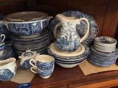 Contents of two shelves: Liberty Blue Historic Colonial Scenes dinnerware set w/ serving pcs