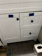 Stool, toilet stools, waste can, blood pressure monitor in box, contents of cabinet under sink and drawer