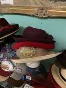 Contents of three shelves: ladies hats and purses, baseball caps,