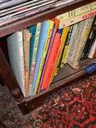 Book contents of three shelves: history, short stories, National Geographics, misc
