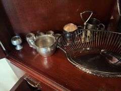 Contents of two shelves: silverplated tea and coffee pots, misc serving pcs