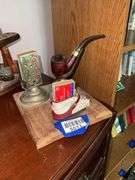 Smoking stand w/ pipe rest, matchbox holder and child's shoe, on wooden base