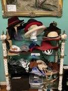 Contents of three shelves: ladies hats and purses, baseball caps,