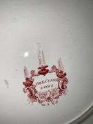 Contents of shelf: red Staffordshire transfer printed plates
