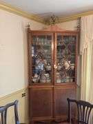 Federal style corner cupboard w/ central eagle finial, glazed top doors over cupboard base, inlaid stringing, French bracket feet - no contents 43x23x94 MUST COME DURING LAST 2 HOURS OF PICKUP FOR THIS ITEM
