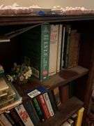 Book contents of three shelves: history, short stories, National Geographics, misc