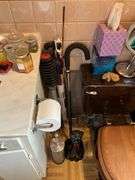 Contents of bathroom except fur coats: collectibles, health items, boots, cleaning supplies, misc
