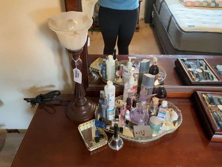 Dresser lamp and mirrored dresser tray w/ contents: perfume bottles, earrings, nail polish, misc