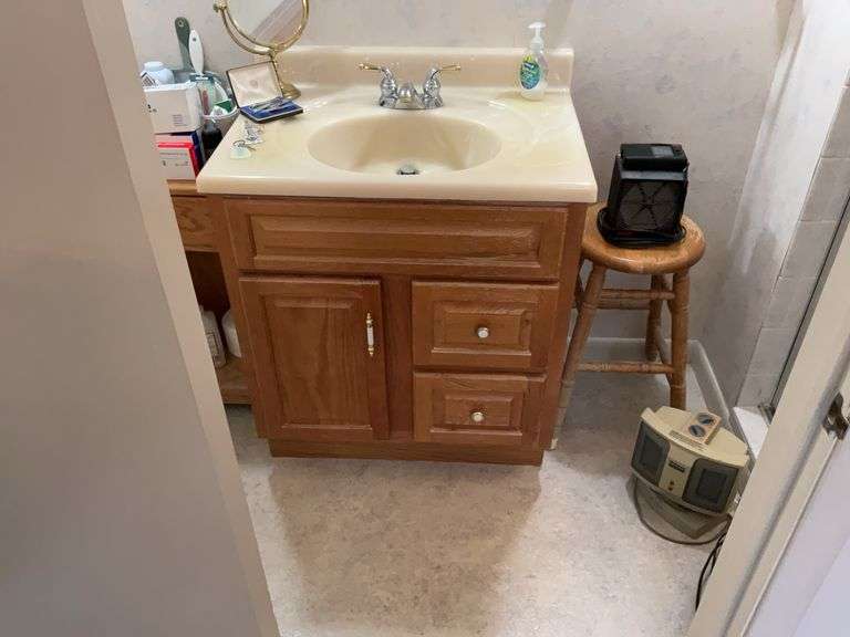 Contents of bathroom off primary bedroom: electric heaters, canes, blow dryer, wooden stool, health products, misc