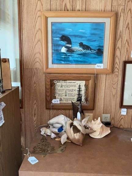 Framed loon print, ship plaque, brass inclinometer, sailfish carving, seashells, carved birds