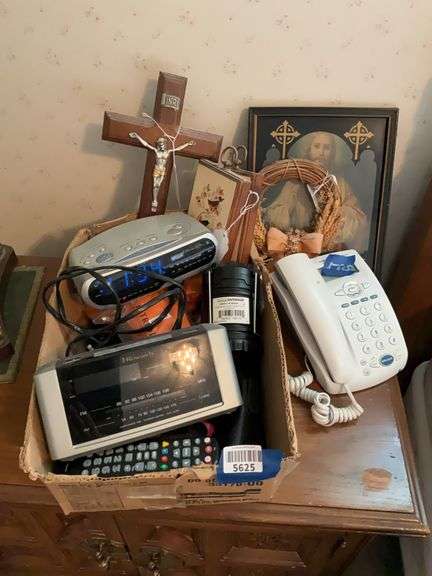 Digital clock/radios, desk telephone, battery lantern, Jesus print, crucifix, plaques, misc