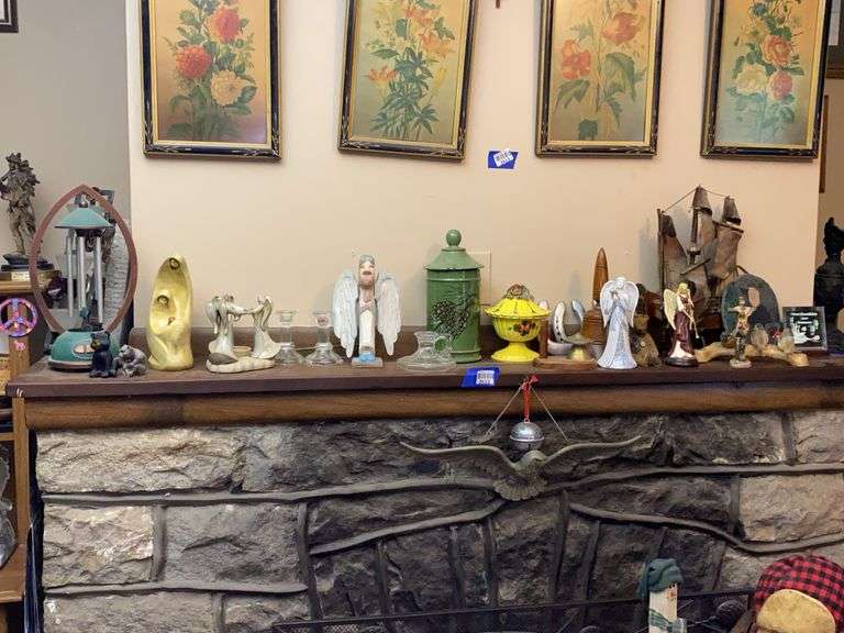 Contents of mantel shelf: electric wind chime, angel figurines, ship model, decor items