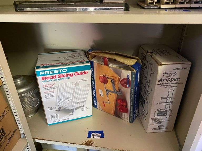 Contents of shelf: aluminum ice bucket, bread slicing guide, apple peeler, Dazey automatic fruit/vegetable peeler