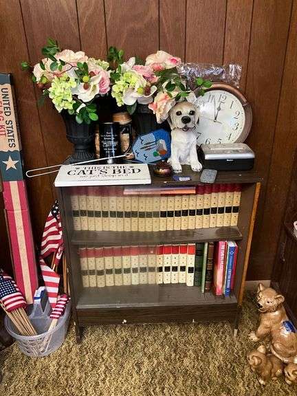 Sliding door bookcase and all contents: encyclopedia, Kodak printer dock, wall clock, dog figurine, decor items 29.5x32x11.75