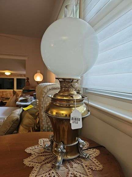 Mixed metal parlor lamp w/ unusual floral filigree central draft burner, lion's head feet, milk glass ball shade, electrified 25 in h