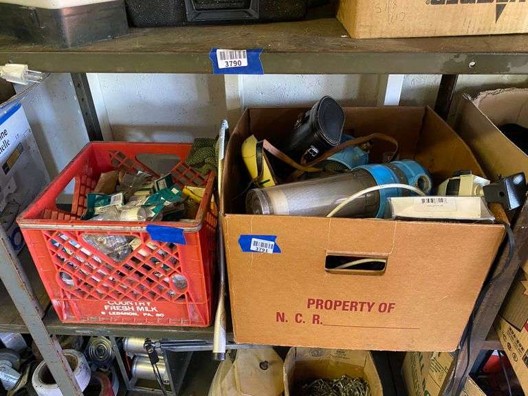 Contents of shelf: milk crate, hose fittings, misc